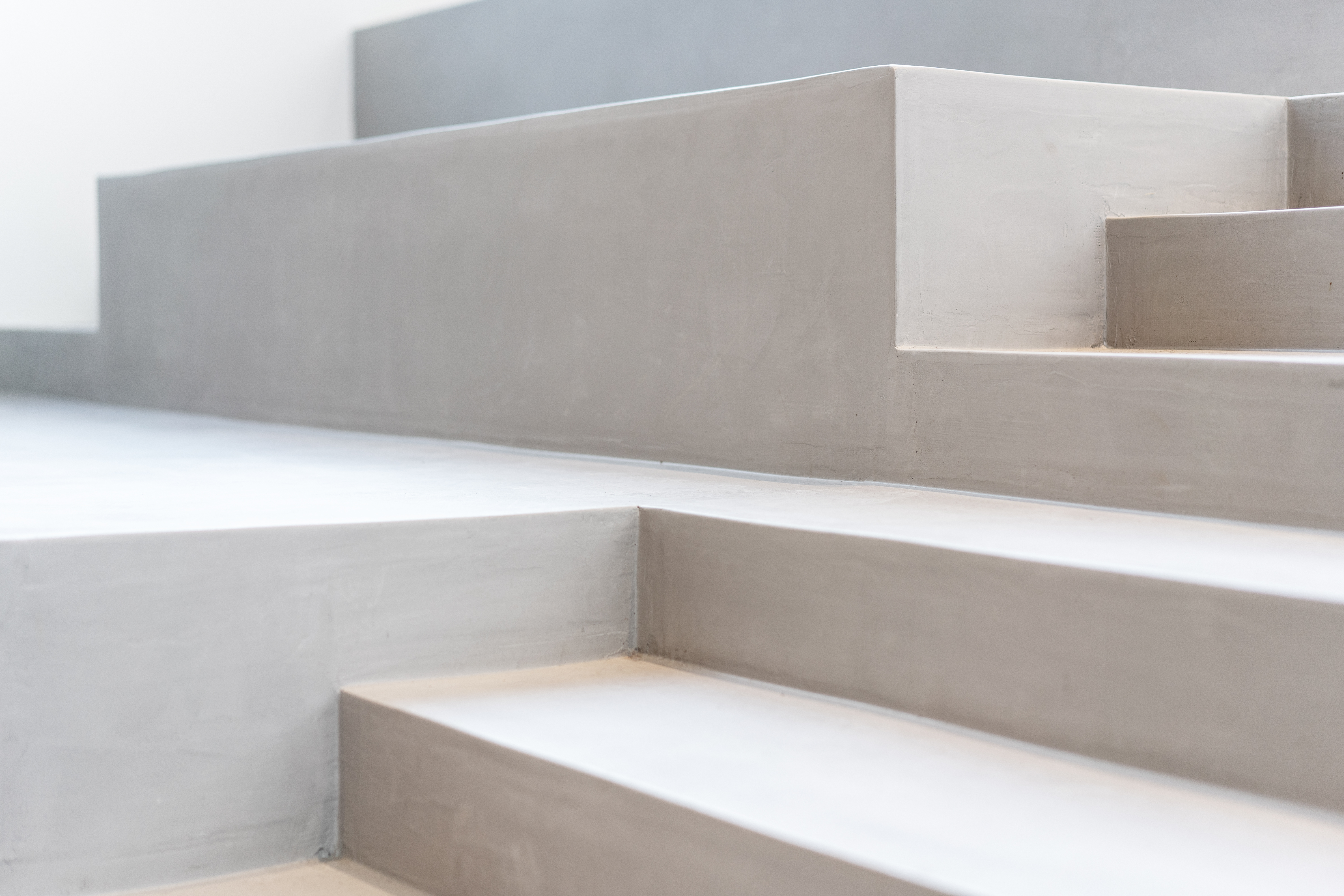 White concrete stairs. Implying the steps in finding the right board member. Watson Inc.