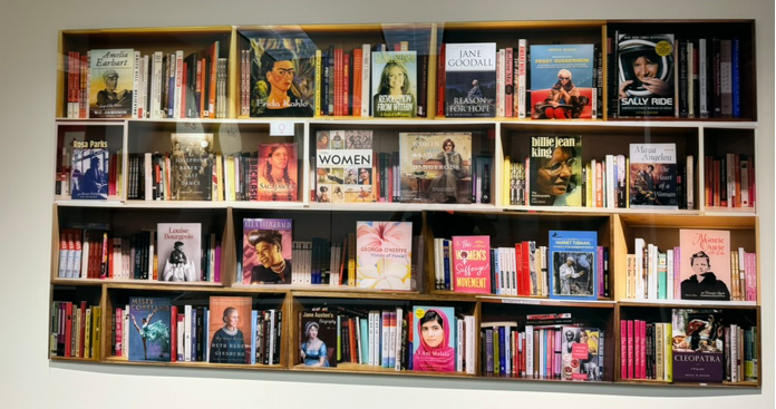 Photo of an art piece by Max Steven Grossman depicting book covers of memoirs and biographies of influential women throughout history | Watson Inc.